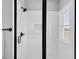 Modern shower with black trim, white walls, and sleek fixtures at 1178 Sheriff Johnson Rd, Lillington, NC 27546