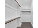 Well-organized walk-in closet offering ample storage with custom shelving and wood rods at 1178 Sheriff Johnson Rd, Lillington, NC 27546