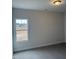 A simple bedroom with neutral carpet, ceiling light and a window offering natural light at 135 Jones Creek Ln Ln, Lillington, NC 27546