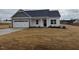 Charming single-Gathering home features a two-car garage, gray accents, and a well-manicured lawn at 135 Jones Creek Ln Ln, Lillington, NC 27546