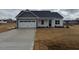 Charming single-Gathering home features a two-car garage, gray accents, and a well-manicured lawn at 135 Jones Creek Ln Ln, Lillington, NC 27546