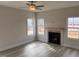 This inviting living room features wood floors, a cozy fireplace, and abundant natural light from large windows at 135 Jones Creek Ln Ln, Lillington, NC 27546