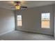 A main bedroom with neutral carpet, ceiling fan and two windows offering natural light at 135 Jones Creek Ln Ln, Lillington, NC 27546
