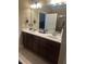 Double vanity bathroom with dark wood cabinets and a large mirror at 166 Easy Wind Ln, Garner, NC 27529