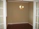 Bright dining room with hardwood floors and a decorative chandelier at 166 Easy Wind Ln, Garner, NC 27529
