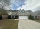 Brick ranch home with a white door and two-car garage at 166 Easy Wind Ln, Garner, NC 27529