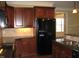 Kitchen with dark wood cabinets and granite countertops at 166 Easy Wind Ln, Garner, NC 27529