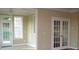 Sunroom with tiled floors and French doors leading outside at 166 Easy Wind Ln, Garner, NC 27529