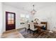 Bright dining room with wooden table, chandelier, and decorative rug at 166 Retreat Dr, Fuquay Varina, NC 27526