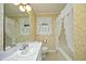Bathroom with bathtub, sink, and floral wallpaper at 1805 Brown Ave, Burlington, NC 27215