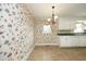 Kitchen dining area with floral wallpaper and tile flooring at 1805 Brown Ave, Burlington, NC 27215