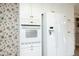 White appliances, including a built-in oven and refrigerator, are featured in this kitchen at 1805 Brown Ave, Burlington, NC 27215
