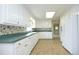 Kitchen with white cabinets, green countertops, and tile floor at 1805 Brown Ave, Burlington, NC 27215