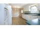 White kitchen with floral wallpaper and tile floor at 1805 Brown Ave, Burlington, NC 27215