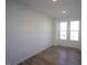 Simple bedroom with wood flooring and large windows at 1924 Robin Hill Ln, Raleigh, NC 27610