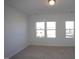 Well-lit bedroom featuring carpet and multiple windows at 1924 Robin Hill Ln, Raleigh, NC 27610