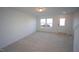 Bright and airy living room with carpeted floor and large windows at 1924 Robin Hill Ln, Raleigh, NC 27610