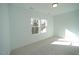 Bright bedroom with carpet and two large windows at 1928 Robin Hill Ln, Raleigh, NC 27610