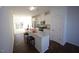Modern kitchen with island, white cabinets, and dark hardwood floors at 1928 Robin Hill Ln, Raleigh, NC 27610