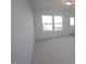 Bright living room with neutral carpeting and large windows at 1928 Robin Hill Ln, Raleigh, NC 27610