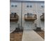 Townhome rear view, showcasing private balconies, attached garages, and a shared driveway at 1928 Robin Hill Ln, Raleigh, NC 27610