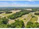 Expansive aerial view of the property showcasing lush landscaping, surrounding trees and neighborhood at 23 Frost Meadow Way, Lillington, NC 27546