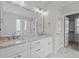 Double vanity bathroom with granite countertop and large mirror at 2923 Logan Valley Path, Apex, NC 27502