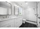 Beautiful bathroom featuring a double vanity, a modern shower, black floor tiles, and neutral wall paint at 313 E Fourth St, Wendell, NC 27591