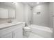 Clean and simple bathroom featuring a bathtub, a marble floor, a sink, and a neutral wall paint at 313 E Fourth St, Wendell, NC 27591