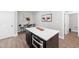 Dining area featuring modern decor, a kitchen island, and stylish hardwood floors at 313 E Fourth St, Wendell, NC 27591