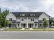 Three-unit townhome building with gray siding and white trim at 313 E Fourth St, Wendell, NC 27591