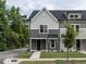 Two-story townhome with gray siding and a dark blue door at 313 E Fourth St, Wendell, NC 27591
