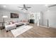 Living room featuring hardwood floors, a gray sofa, a ceiling fan, and a refreshment area at 313 E Fourth St, Wendell, NC 27591