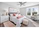 Bright main bedroom with a ceiling fan, hardwood floor, a bedside table, and ample natural light at 313 E Fourth St, Wendell, NC 27591