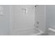 Bathroom with white subway tile, a bathtub and shower at 402 Sparella St, Durham, NC 27703