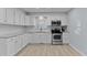 Modern kitchen with white cabinets, stainless steel appliances, and granite countertops at 402 Sparella St, Durham, NC 27703