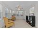 Bright sunroom with two armchairs, a ceiling fan, and wood-look flooring at 402 Sparella St, Durham, NC 27703