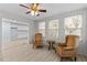 Bright sunroom with two armchairs and view into kitchen at 402 Sparella St, Durham, NC 27703