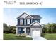 Two-story home with blue siding, white trim, and a two-car garage at 4214 Darroch Rd, Lillington, NC 27546