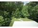 Large backyard with lush green grass and trees at 508 Lakeland St # A, Durham, NC 27701