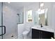 Modern bathroom with marble shower, vanity with quartz countertop, and black fixtures at 508 Lakeland St # A, Durham, NC 27701