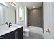 Clean bathroom with gray tile and a bathtub at 508 Lakeland St # A, Durham, NC 27701
