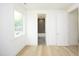 Simple bedroom with wood floors and en-suite bathroom at 508 Lakeland St # A, Durham, NC 27701