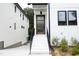 Modern front entrance with wood door and black metal railing at 508 Lakeland St # A, Durham, NC 27701