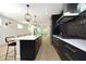 Open concept kitchen with island, stainless steel appliances, and hardwood floors at 508 Lakeland St # A, Durham, NC 27701