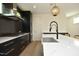 Modern kitchen features a concrete sink, quartz countertops, and black cabinetry at 508 Lakeland St # A, Durham, NC 27701