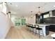 Open concept kitchen with island, stainless steel appliances, and dark cabinets at 508 Lakeland St # A, Durham, NC 27701