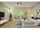 Spacious living room with hardwood floors and sliding doors to balcony at 508 Lakeland St # A, Durham, NC 27701