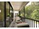 Cozy screened porch with wicker furniture, overlooking a wooded area at 508 Lakeland St # A, Durham, NC 27701
