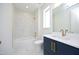 Modern bathroom with marble shower and navy blue vanity at 508 Lakeland St # B, Durham, NC 27701